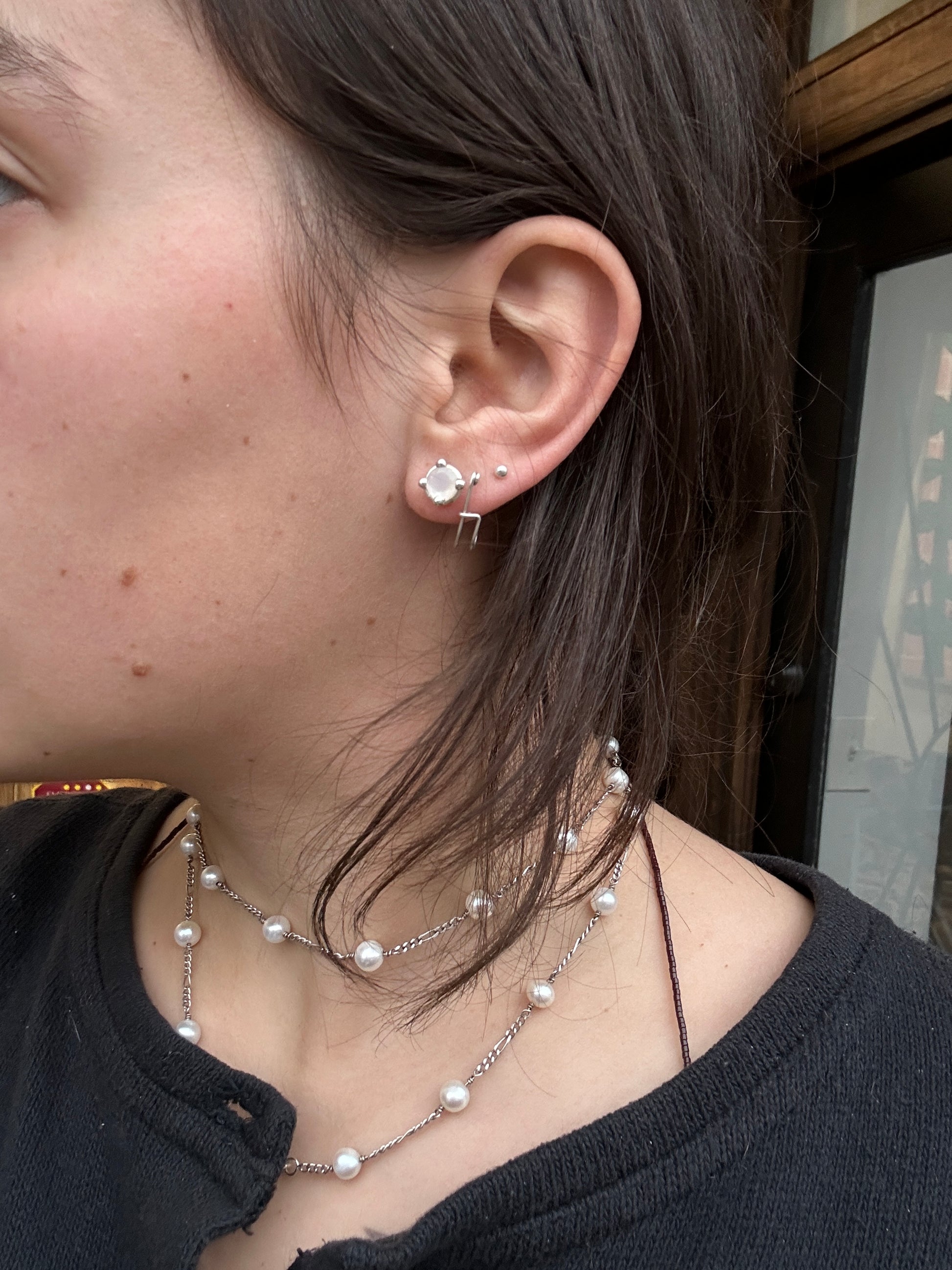 Close up of a brunette model's ear/neck wearing the earrings.