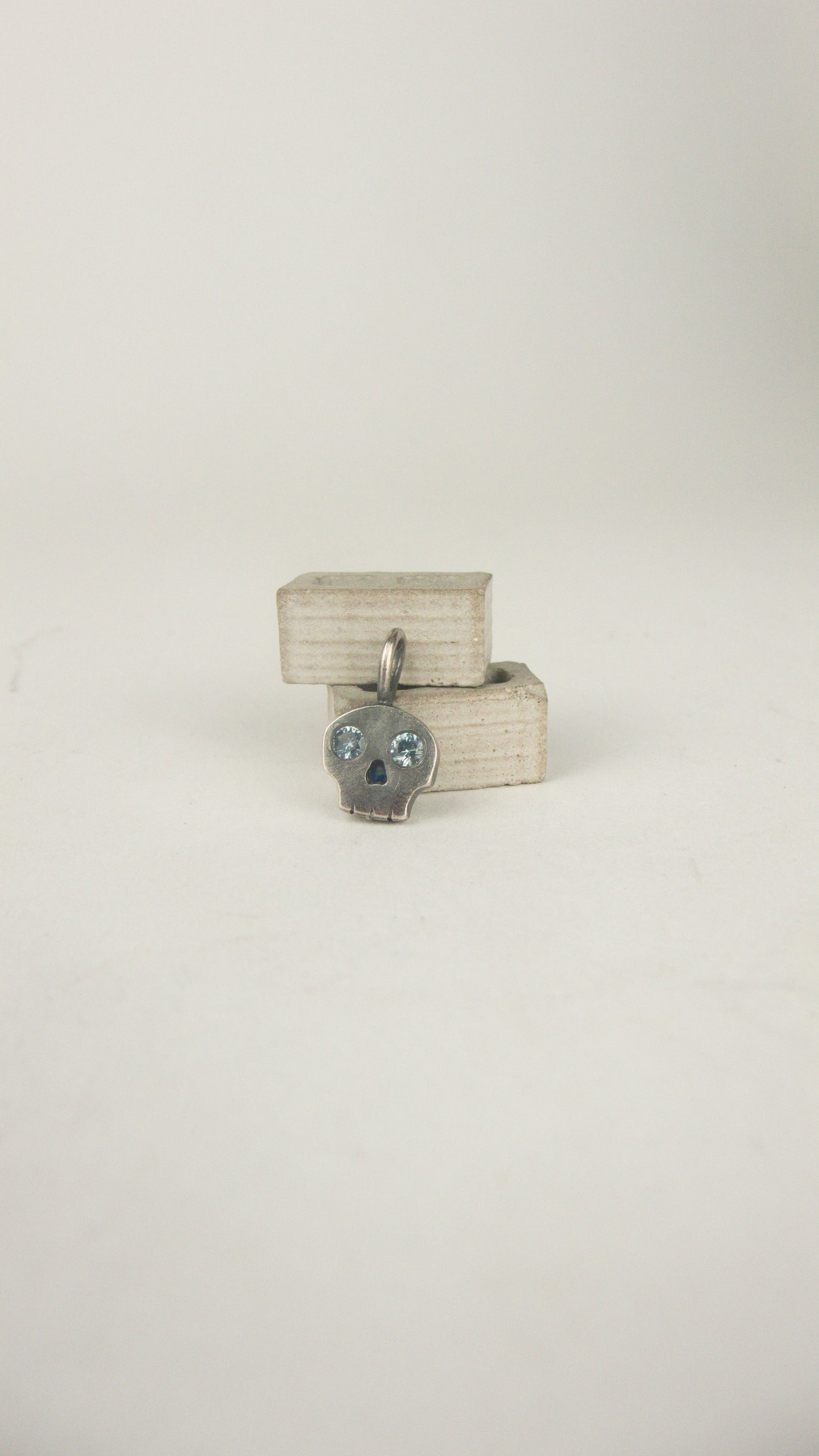 Skull Charm with Sapphire Eyes